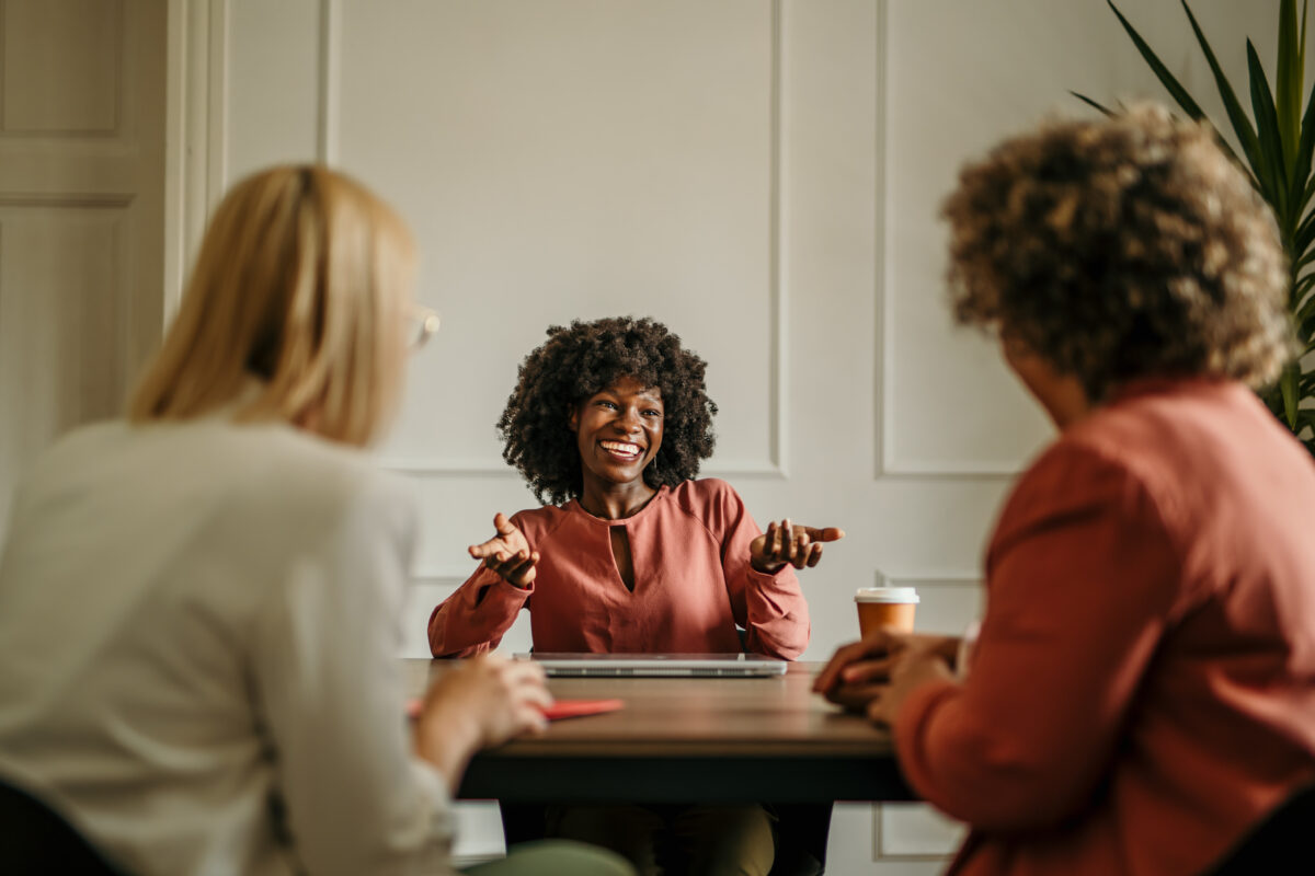 Happy businesswoman sharing ideas with her colleagues during a productive meeting in the office