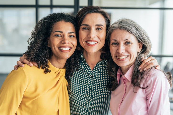 3 women smiling at the camera