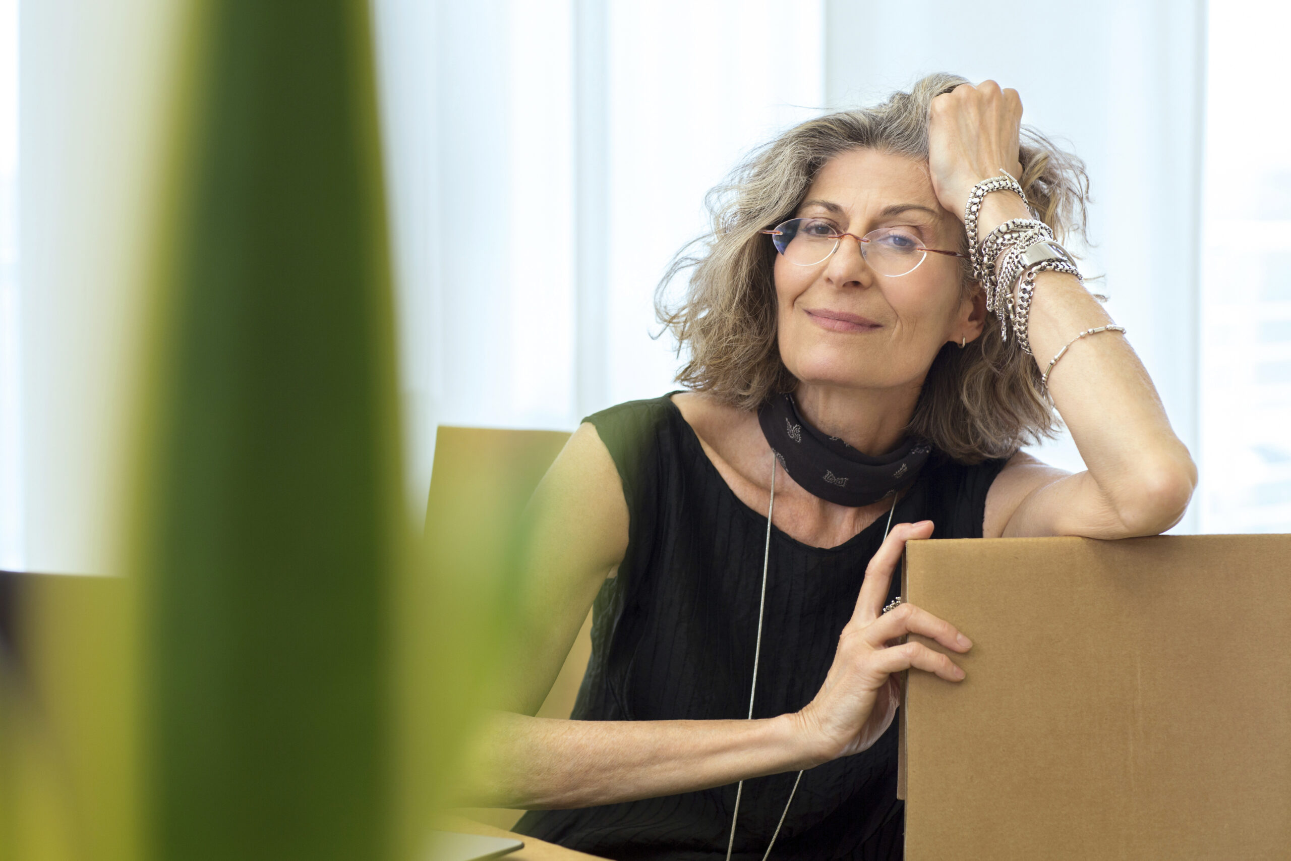 Portrait of senior businesswoman relaxing on office chair