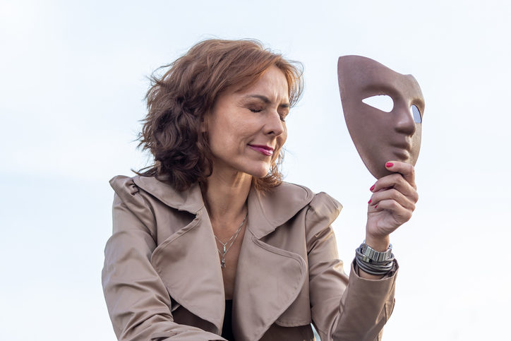 woman holding a face mask